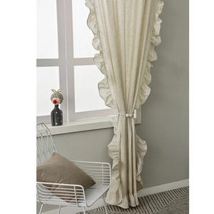Detail of beige ruffled cotton linen curtain with elegant white beaded tieback accessory