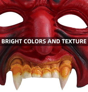 Close-up of red demon mask showing realistic skin texture and yellow fangs for Halloween