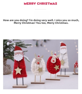 Detailed view of Christmas felt dolls with wooden bases and sparkly gold star accents