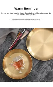 Close-up of golden stainless steel trays showing premium brushed metal texture and round design