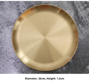 Detailed top view of 26cm round gold metal tray with brushed finish texture