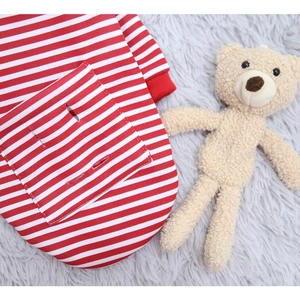 Detail of red and white striped dog sweater with leash hole and soft knit texture