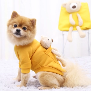Detail of bright yellow pet fleece hoodie with cute brown 3D bear doll decoration