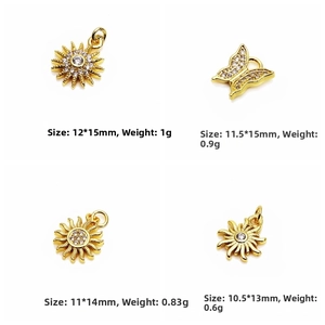 Macro view of gold plated sun and butterfly charms with micro-pave cubic zirconia details