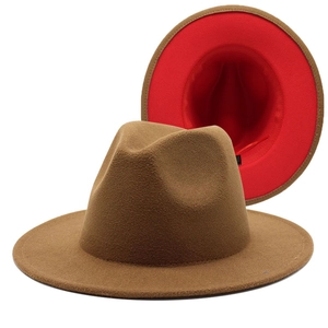 Detail of two-tone wool fedora hat showing camel exterior and vibrant red interior