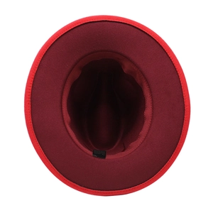 Detailed top view showing bicolored felt fedora hat interior with red and black wool texture