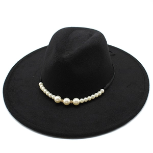 Detailed close-up of a black wool fedora featuring a luxury pearl and gold rhinestone band