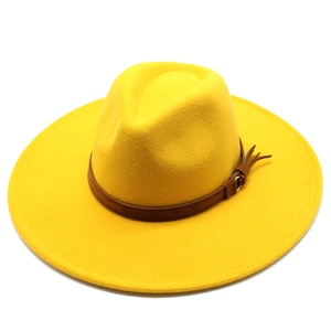 Detail view of yellow wool felt fedora hat featuring a brown leather band and buckle