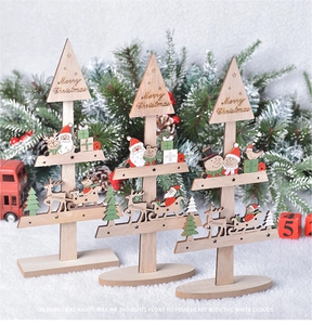 Close-up of three-tier wooden Christmas tree tabletop ornaments with Merry Christmas text