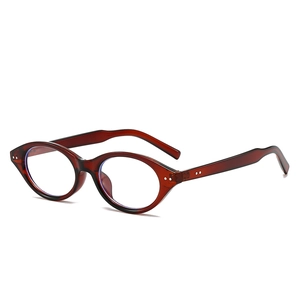 Retro reddish brown oval frame glasses with metal dot detail shown from a 45-degree angle