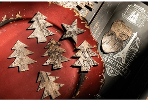 Macro detail of natural bark wood ornaments in tree, star, and heart shapes for Christmas