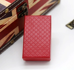 Macro shot of red rectangular gift box with diamond texture on British flag background