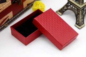 Detailed view of a red diamond-textured jewelry gift box with premium black velvet lining