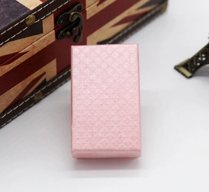 Pink diamond-textured jewelry gift box featured on a vintage wooden background decor