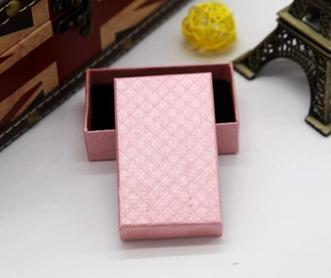 Pink diamond-textured jewelry box with black velvet lining for rings and necklaces