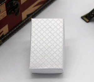 Detailed view of a white rectangular jewelry box featuring a premium diamond-textured finish