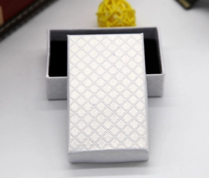 Close-up of silver rectangular jewelry box with diamond texture and black velvet lining