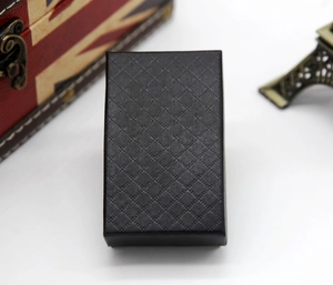 Close-up of black rectangular jewelry box with diamond texture on a vintage background