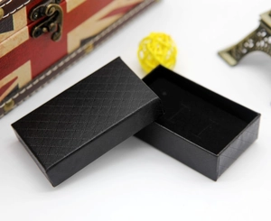 Macro view of black diamond-textured jewelry box with velvet lining for necklaces