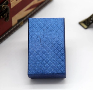 Overhead shot of a blue rectangular jewelry gift box with textured diamond pattern finish