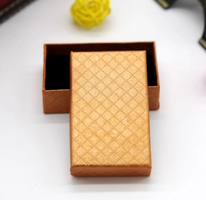 Macro detail of golden diamond-pattern jewelry box with premium black velvet interior lining