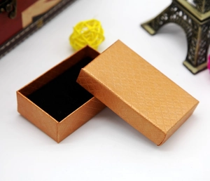 Detail of orange textured jewelry box with black sponge lining and Eiffel Tower decor