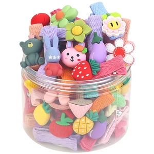 Colorful set of kids hair clips with cartoon and fruit patterns in a clear storage jar
