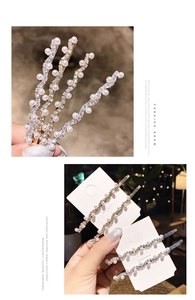 Detail of wavy gold and silver hair clips with white pearls and sparkling rhinestones
