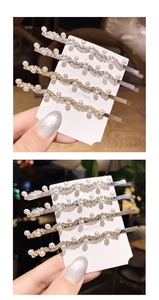 Detailed view of four wave-shaped hair clips with artificial pearls and rhinestones
