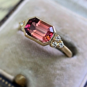 Gold plated ring with rectangular pink gemstone and round zircon in beige velvet box