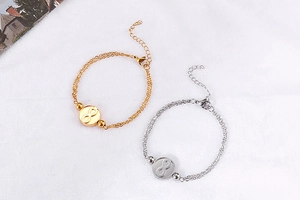 Detail of double-layer gold and silver infinity bracelets with lobster clasp and extension