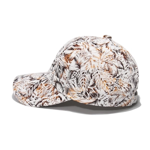 White cotton baseball cap with tropical brown leaf prints and curved brim for women