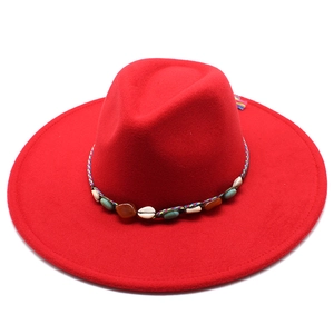 Detail of red wool felt fedora with ethnic woven band featuring shell and agate stones