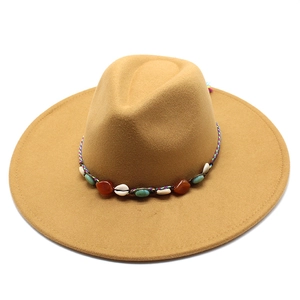 Close-up of ethnic woven band with turquoise and shells on camel wool fedora hat