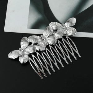 Detailed close-up of a silver alloy hair comb featuring three tiered 3D butterflies