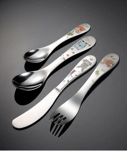 Close-up of 4-piece stainless steel kids cutlery set with cartoon animal patterns