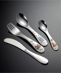 Detailed macro view of 4-piece SUS 304 stainless steel kids cutlery with animal engravings