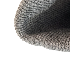 Detailed macro view of gray knitted fabric texture and vertical ribbed stitch pattern