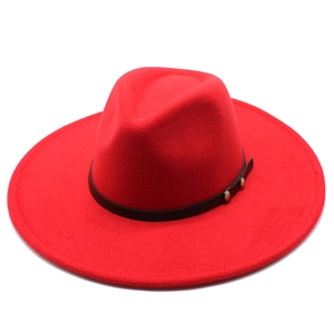 Close-up of red wide brim wool fedora with black leather band and silver rivet accents