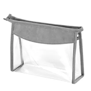 Transparent trapezoidal toiletry bag with grey suede trim and metal zipper detail