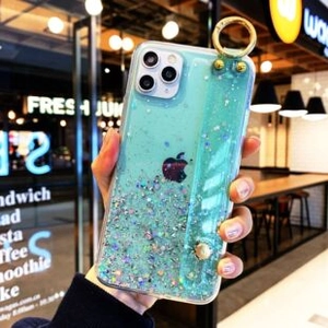 Macro detail of gradient green glitter phone case with gold ring kickstand for iPhone