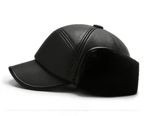 Side view of winter earflap hat in black pebble leather with soft faux fur lining