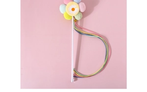 Detail of colorful plush flower teaser wand with rainbow ribbons on pink background