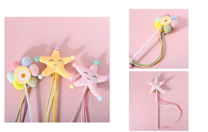 Detail of plush flower and starfish cat wand with bells and colorful ribbons