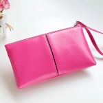 Detailed view of the rose red PU leather makeup bag with wristlet and zipper closure