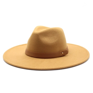 Detail of camel wool fedora hat featuring a brown leather band and gold metal stud