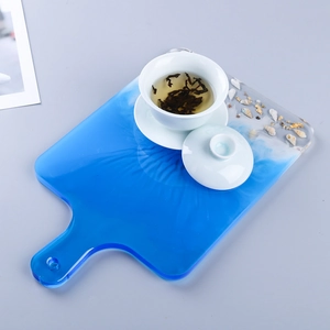 Detail of ocean theme resin tray with embedded shells and beach wave sand texture
