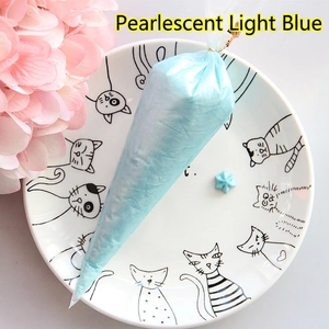 Pearlescent light blue cream glue in a piping bag for DIY phone case and crafts