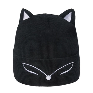 Close-up of animal ear knit beanie with white fox embroidery and ribbed texture