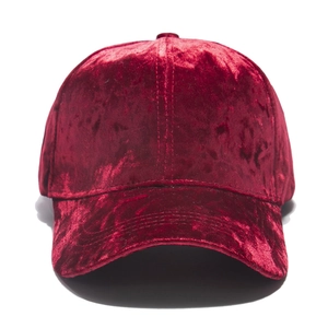 Detail of red velvet baseball cap showing premium soft texture and curved brim